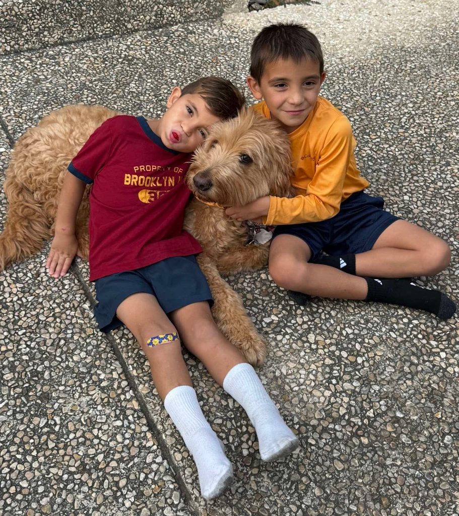 goldendoodle puppy with two boys- Rainfield Goldendoodles Review